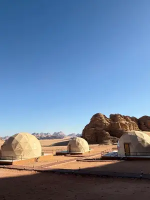 a group of domes in a desert with rocks at Kadi Wadi Rum in Al Jafr