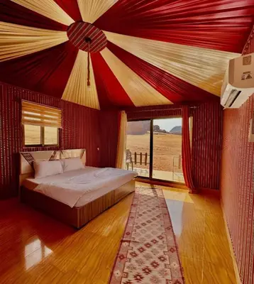 a bedroom with a bed with a red ceiling at wadi rum luxury bubble soul in Wadi Rum