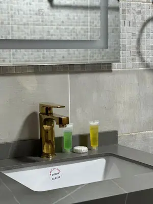 a sink with two glasses of beer on a counter at wadi rum luxury bubble soul in Wadi Rum