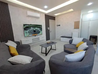 a living room with two couches and a tv at منزل السعادة in Amman
