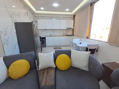 a living room with a couch with yellow pillows at منزل السعادة in Amman