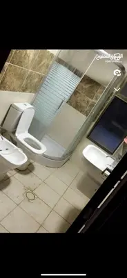 a bathroom with two toilets in a room at Apartment in Al Jafr