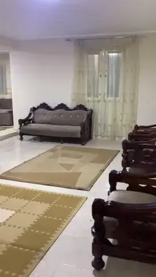 a living room with a couch and a chair at مليح هوستل