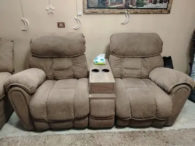 a living room with two chairs and a table at مليح هوستل