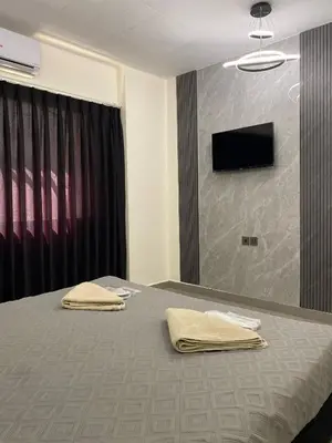 a bedroom with a bed with two towels on it at Eden Hotel in Aqaba