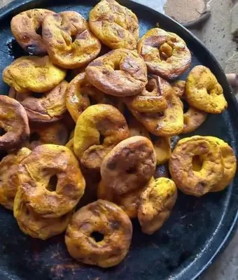 a pile of donuts sitting on a blue plate at وادي الشلاله هاوس in Al Mughayyir