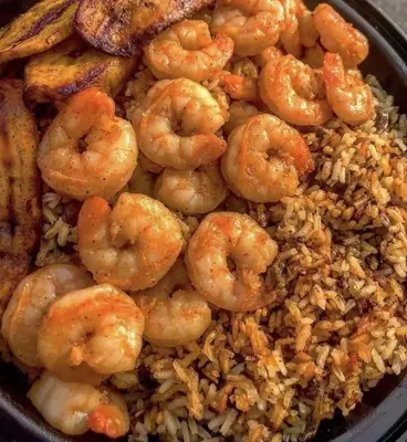 a plate of shrimp and rice on a table at وادي الشلاله هاوس in Al Mughayyir