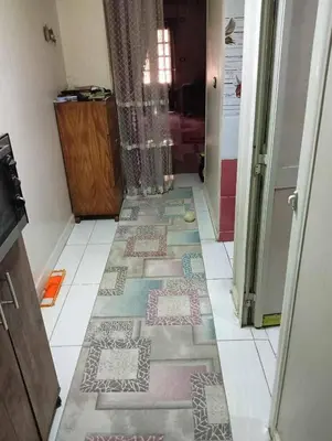 a hallway with different colored tiles on the floor at وادي الشلاله هاوس in Al Mughayyir