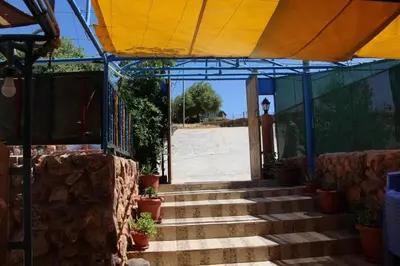 a set of stairs leading to the entrance to a building at استراحة ومنتجع قرية الزرب in Ajloun