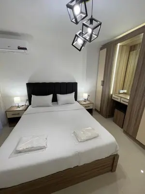 a bedroom with a large bed with two towels on it at 2bedroom aprt at 7th circle f-r4 in Amman