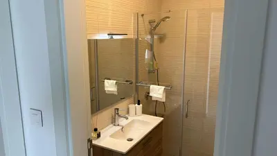 a bathroom with a sink and a shower at Ayla Aqaba Azure 2 bedroom in Aqaba