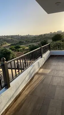 a balcony with a view of the countryside at شاليه جبال سوف in Jerash