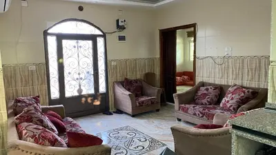a living room with two couches and a window at شاليه جبال سوف in Jerash