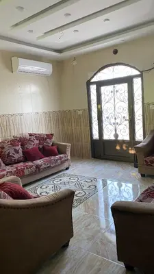 a living room with two couches and a window at شاليه جبال سوف in Jerash