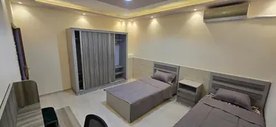 a room with a bed and a couch and a window at الريان in Amman