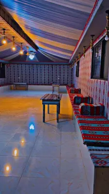 a room with couches and a table in it at SAHARA ECHO CAMP& Tour in Wadi Rum