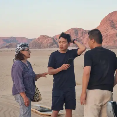 a group of three people standing in the desert at SAHARA ECHO CAMP& Tour in Wadi Rum