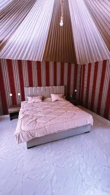 a bedroom with a bed in a tent at SAHARA ECHO CAMP& Tour in Wadi Rum