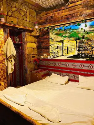 a bed in a room with a painting on the wall at بيت جدي in Dana