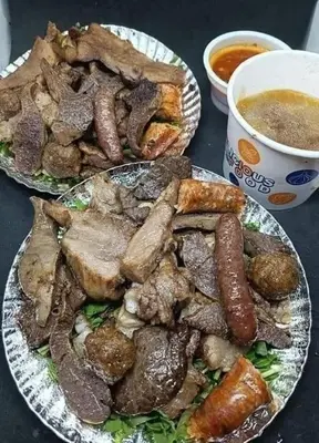 two plates of food with meat and a bowl of soup at الزواهره هاوس in Az Zarqa