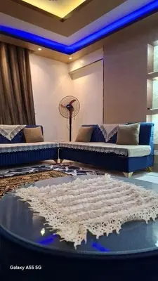 a living room with two couches and a table at الزواهره هاوس in Az Zarqa