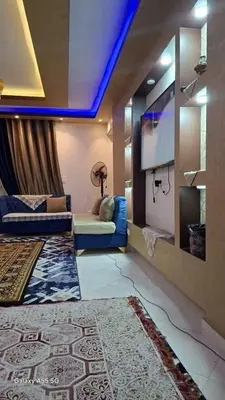 a living room with a couch and a tv at الزواهره هاوس in Az Zarqa