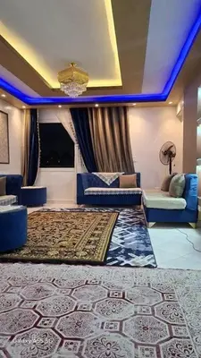 a living room with a couch and a rug at الزواهره هاوس in Az Zarqa