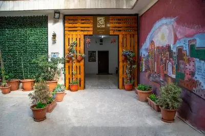 a hallway with potted plants and a painting on the wall at Antika Amman Hotel in Amman