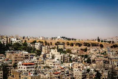a view of a city with buildings on a hill at Antika Amman Hotel in Amman
