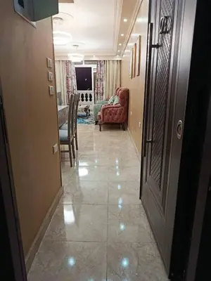 a hallway with a living room with a couch and a door at رميمين هاوس