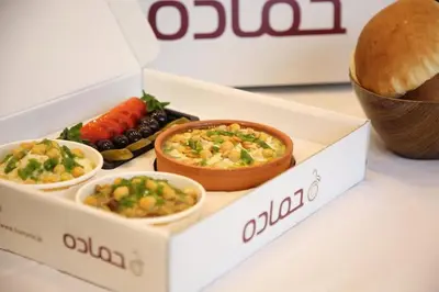 a box with three different types of food in it at Old Town Hotel in Aqaba