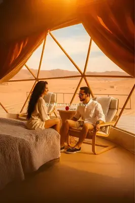 a man and woman sitting in a tent in the desert at Rum marco luxury camp in Wadi Rum