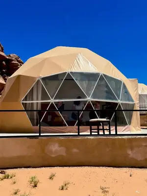 a tent with people sitting in it in the desert at Rum marco luxury camp in Wadi Rum