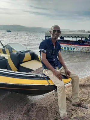 a man sitting on the front of a boat at Tourist guide in Al Jafr