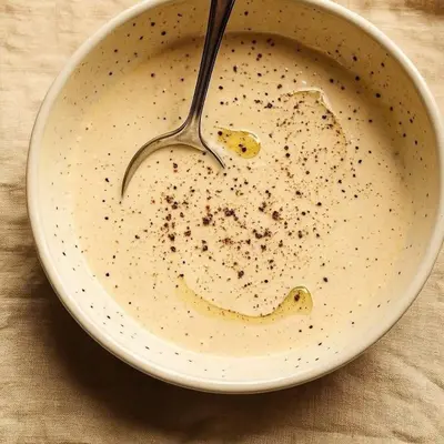a bowl of milk with a fork in it at سونا موتل in Sūf