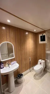 a bathroom with a toilet and a sink and a mirror at Wadi Rum Sand Camp in Al Jafr