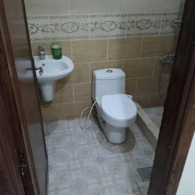 a bathroom with a toilet and a sink at New Room in Aqaba