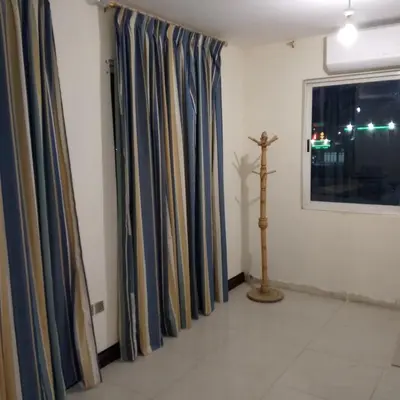 a room with curtains and a cross on a window at New Room in Aqaba
