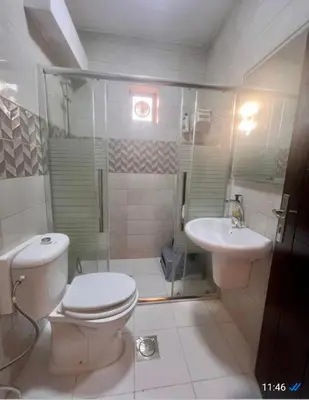 a bathroom with a toilet and a sink at Janna2Villa in Shūnat Nimrīn