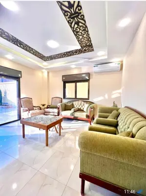 a living room with couches and a table at Janna2Villa in Shūnat Nimrīn