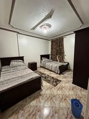 a bedroom with two beds and a ceiling at فلورس لوج
