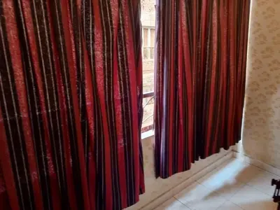a room with red curtains and a window at فلورس لوج
