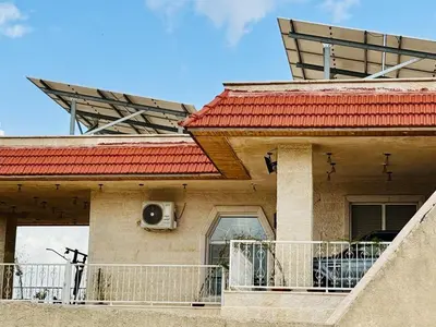a house with a dog sitting on a balcony at مزرعة وشالية هوى الوادي