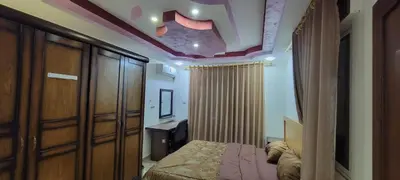 a bedroom with a bed in a room with a ceiling at النخبة للشقق الفندقية AlNukhba suites in Irbid