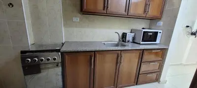a small kitchen with a sink and a microwave at النخبة للشقق الفندقية AlNukhba suites in Irbid