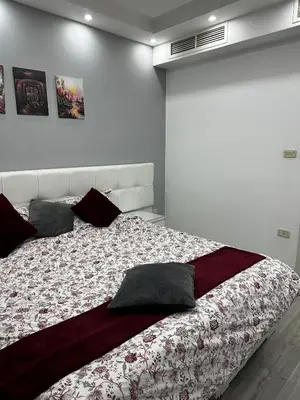 a bedroom with a large bed with pillows on it at alrabyeh studio 21 استوديو الرابية in Amman