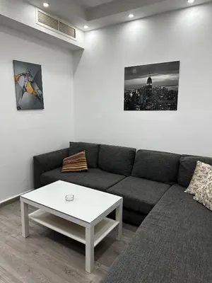 a living room with a couch and a coffee table at alrabyeh studio 21 استوديو الرابية in Amman