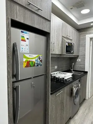 a kitchen with a stainless steel refrigerator and a sink at alrabyeh studio 21 استوديو الرابية in Amman