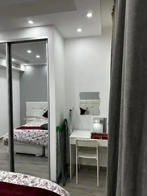 a bedroom with a mirror and a bed and a desk at alrabyeh studio 21 استوديو الرابية in Amman