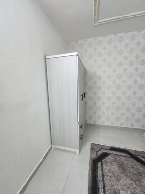 a white cabinet in a room with a rug at اللجين 6m in Irbid